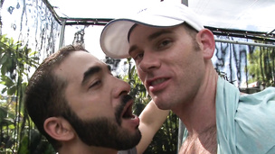 Bearded twink kisses and touches his lover in the garden